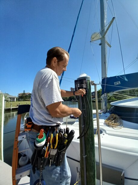SunCoast Electrical Contractors working on power supply for a boat dock